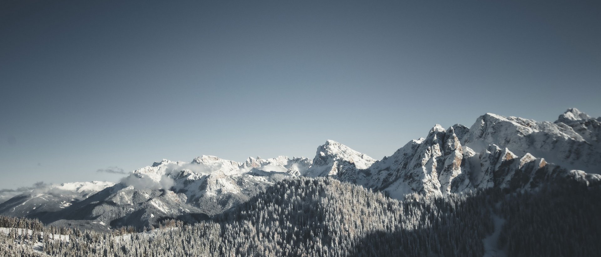 Unser Hotel in Olang zwischen Himmel und Erde Schneebedeckte Berge unter klarem Himmel